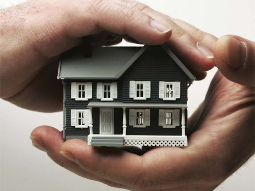 person holding house model